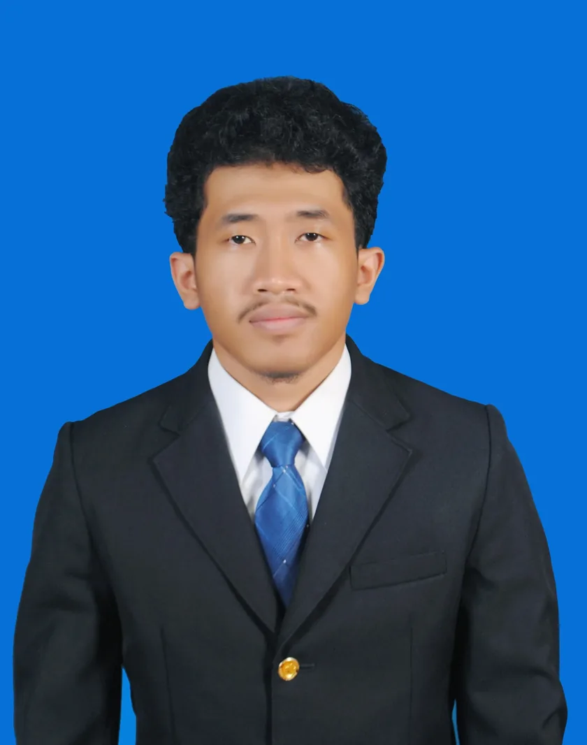 Foto formal Avril Irvan Faradilach mengenakan jas hitam dan dasi biru dengan latar biru